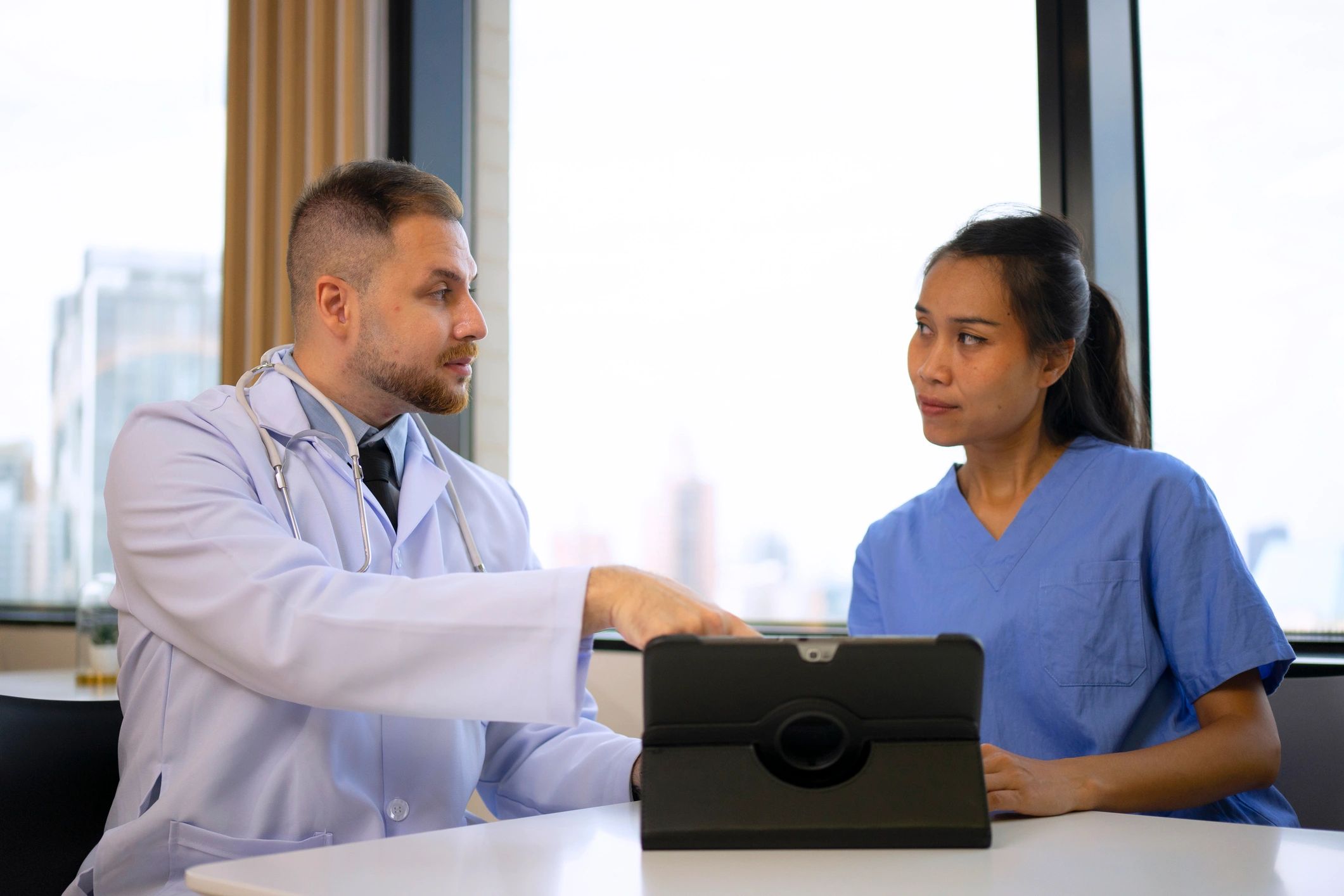 Doctor using a digital tablet in clinic