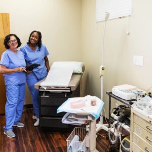 Two female healthcare workers in examination room